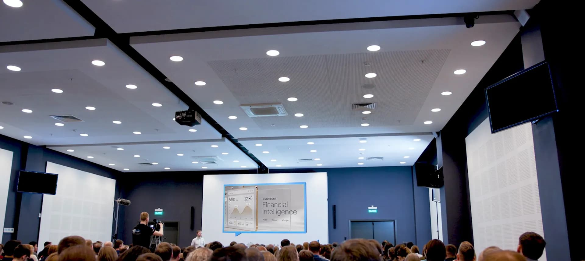 A session in a conference room, the audience facing the presenter's screen